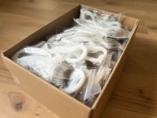 Box of 2500 grey fiber 145P tags with waxed lacing cord attached, bulk packaging