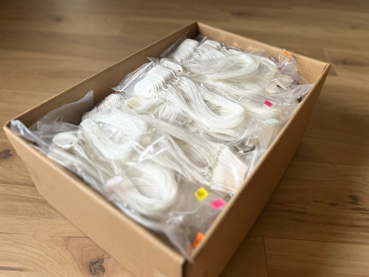 Box of 2500 white 145P tags with waxed lacing cord attached, bulk packaging