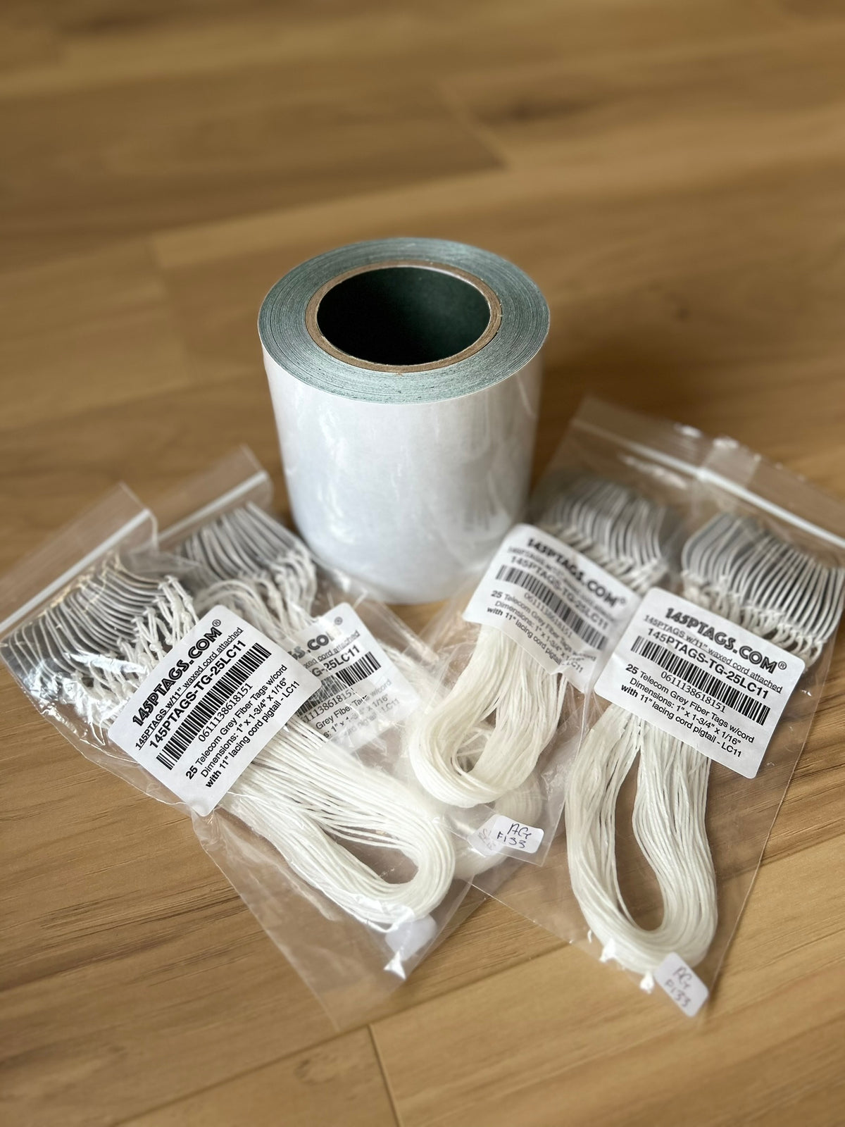 Adhesive fish paper roll bundle, 5 inch x 50ft, with 100 telecom grey 145P tags and waxed lacing cord