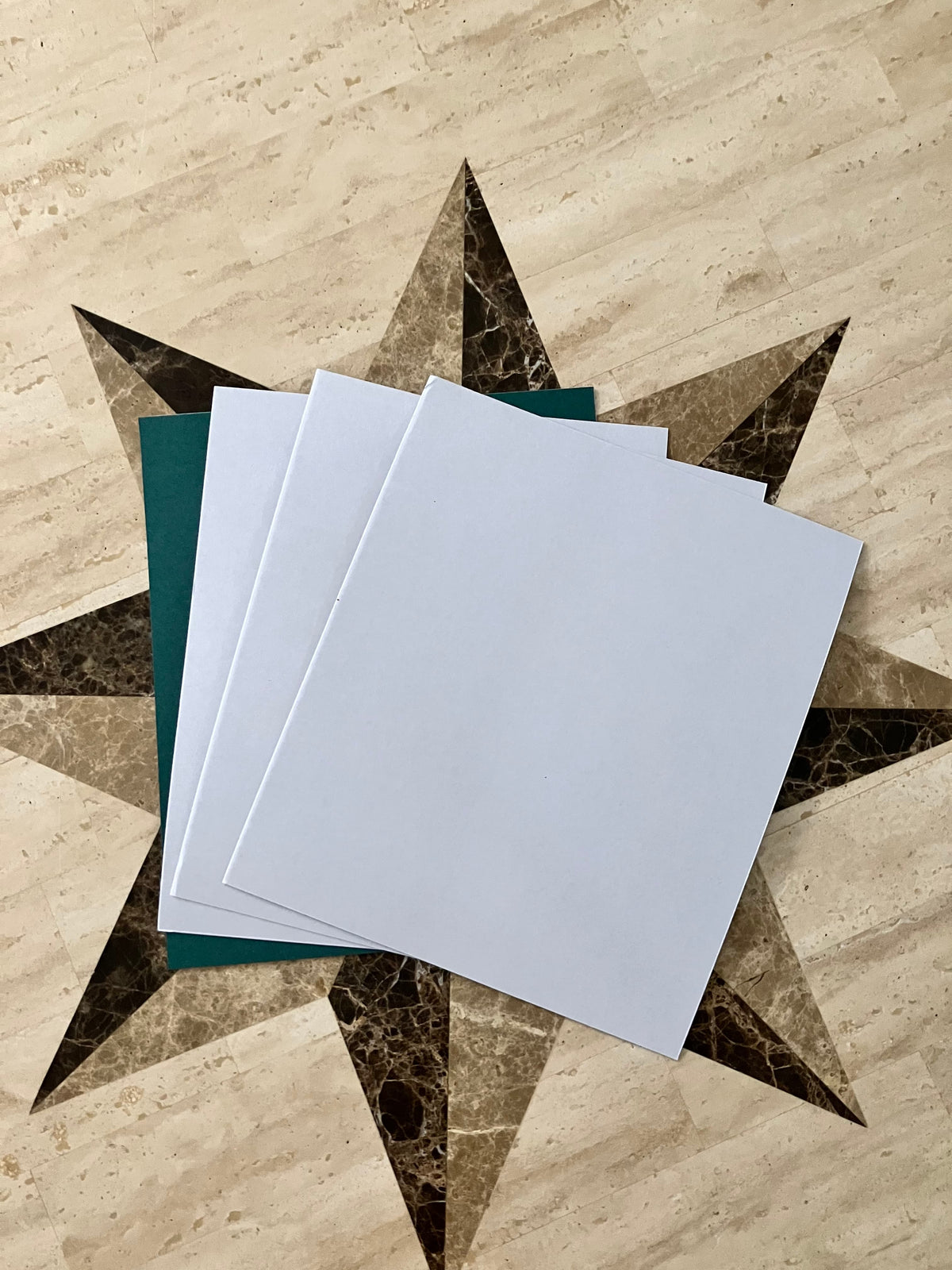 Set of four white adhesive-backed fish paper sheets, liner side shown, 10.5 x 9 inches