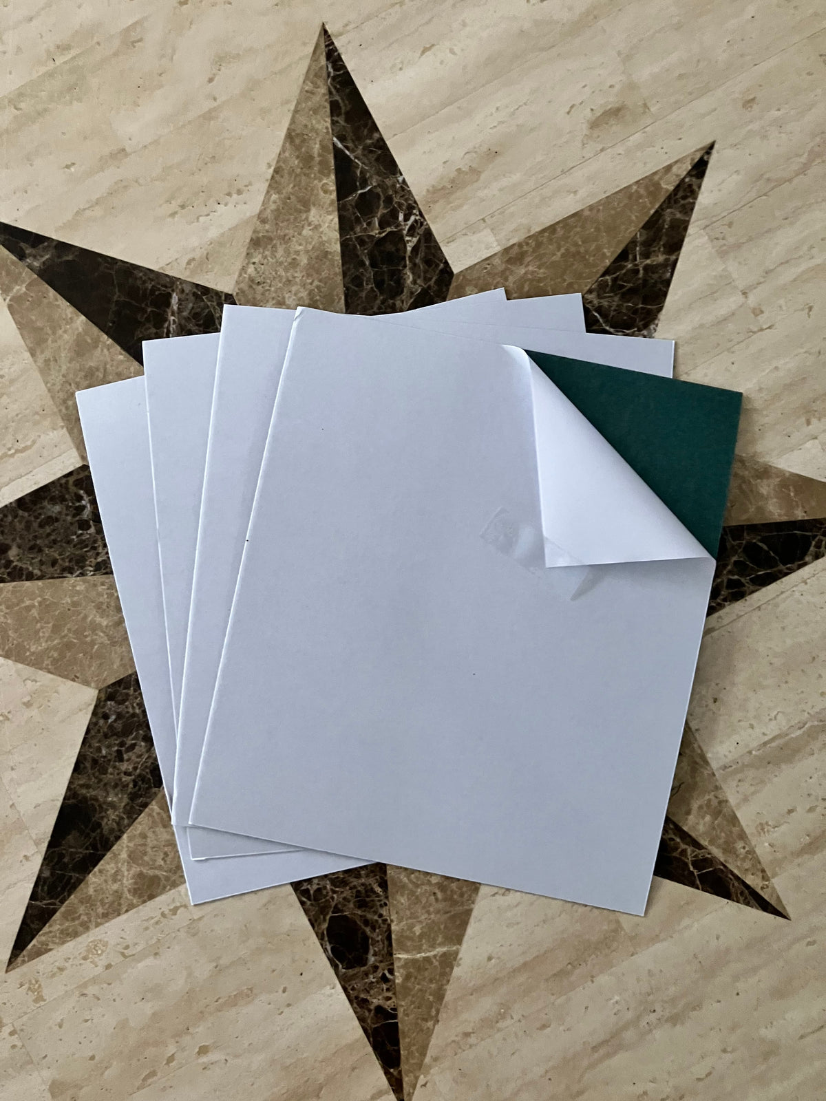Set of four (4) white adhesive-backed fish paper sheets, liner side shown, 10.5 x 9 inches